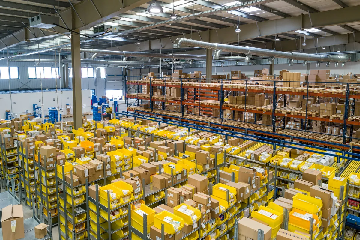 Retail distribution warehouse with tall racks arranged by logistics flow.